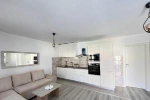 a living room with a couch and a kitchen at House9 in Kotor