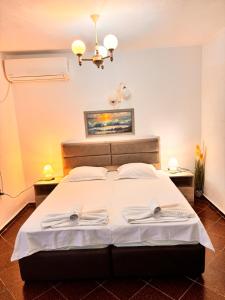 a bedroom with a bed with two towels on it at Apartments Yana in Obzor