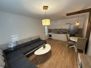 a living room with a couch and a table at Apartman Sueno Foca in Foča