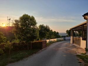 a road next to a house with the sunset in the background at Casa Tone in Grdoselo