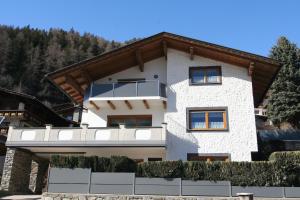 a building with a balcony on the side of it at Haus Remler in Matrei in Osttirol