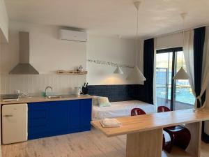 a kitchen with a sink and a bed in a room at Thalassea Apartments in Himare