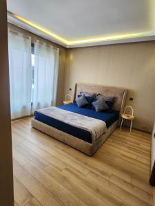 a bedroom with a bed with blue sheets and blue pillows at Seaside, Infinity Pools, Gym, Games, Wifi in Tamaris +20 photos