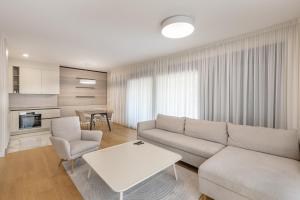 a living room with a couch and a table at Luxury Apartment Sunscape near Portonovi in Herceg-Novi +35 photos