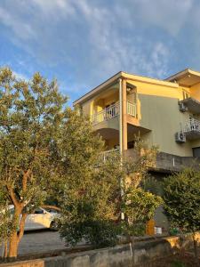 a building with a car parked in front of it at Rooms Raguž in Neum