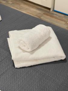 a pile of white towels sitting on the floor at Casa Maria-Anneta in Kalyves Poligirou