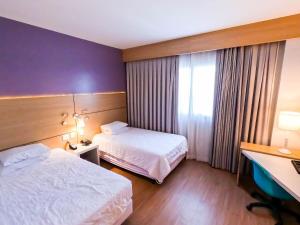 Stay Inn Santos Sua acomodação com cara de Hotel客房内的一张或多张床位