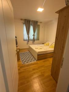 a small room with a bed and a window at Vacations Apartment, 50 m from the beach in Golem