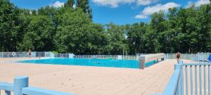 a large swimming pool with people in it at Appartement Vue sur Lac in Monflanquin