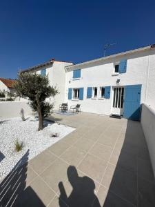 a shadow of a person taking a picture of a building at La Villa Delphine in Vaux-sur-Mer