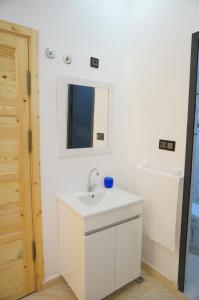 a bathroom with a white sink and a mirror at 2 Voies Résidence in Dakhla +158 photos