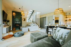 a living room with a couch and a table at Krzywe Pearl Chalets in Krywe