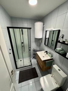 a bathroom with a shower and a toilet and a sink at Holiday Village 8C in Senec