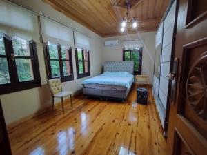 a bedroom with a bed and a chair in it at Asiye Hanım Konağı in Trabzon