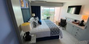 a bedroom with a large bed and a window at Hotel HBlue Malecón in La Paz