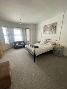 a large bedroom with a bed and a couch at Abchuch chambers in Bournemouth