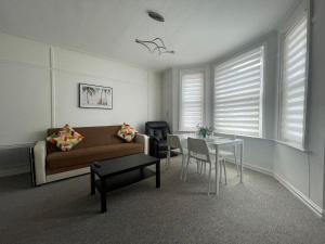 a living room with a couch and a table at Abchuch chambers in Bournemouth