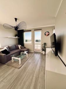 a living room with a couch and a tv at Apartament Panorama Żory in Żory