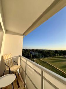 a balcony with a table and chairs and a view at Apartament Panorama Żory in Żory