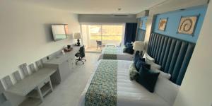 a living room with two couches and a couch at Hotel HBlue Malecón in La Paz