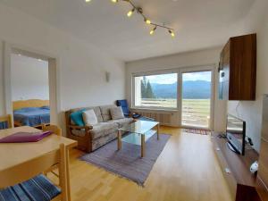 a living room with a couch and a table at Apartment in Sonnenalm - Salzkammergut 37018 in Reith