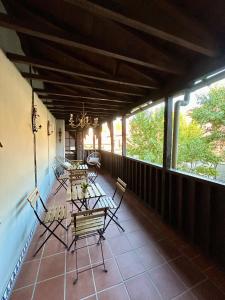 a patio with tables and chairs on a balcony at Casa Alba in Alcalá de Henares +21 photos