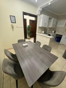 a dining room table and chairs in a kitchen at Al Diyafah Apt in Medina +8 photos