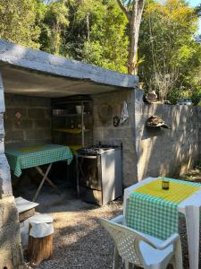 an outdoor kitchen with a stove and a table at Camping do SER - Beliche in Petrópolis