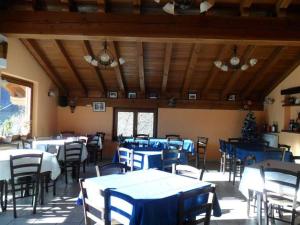 a dining room with tables and chairs and a christmas tree at Ristoro Saint Roch in Hone +34 photos