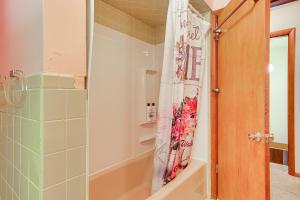 a bathroom with a shower curtain and a tub at Private 5-Acre Lake Pet-Friendly Grove City Home in Grove City +17 photos