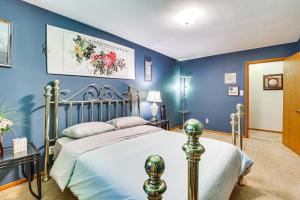 a bedroom with a bed and blue walls at Private 5-Acre Lake Pet-Friendly Grove City Home in Grove City
