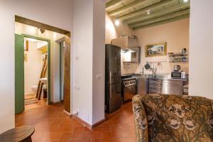 a kitchen with a refrigerator and a stove top oven at Campucetto Rosso 5 Min from Duomo with Garden and AC in Florence
