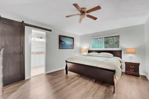 a bedroom with a bed and a ceiling fan at Serene Deck 10 Mins Garland City Square in Garland