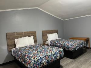 a hotel room with two beds at Sun N Sand Motel in Spartanburg