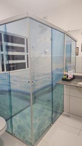 a glass shower in a bathroom with water at Nobre Flats 201 in Petrolina +10 photos