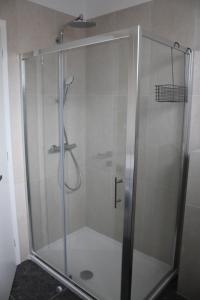a shower with a glass door in a bathroom at Wiki in Vodice +27 photos