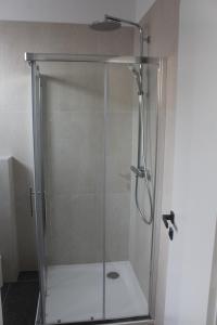 a shower with a glass door in a bathroom at Wiki in Vodice +27 photos