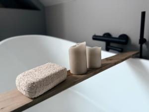 a shelf with two towels and two candles on a bed at Full house with stunning view near Pulpit rock in Jørpeland +23 photos