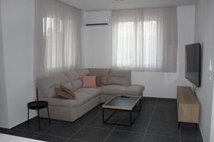 a living room with a couch and a tv at Wiki in Vodice