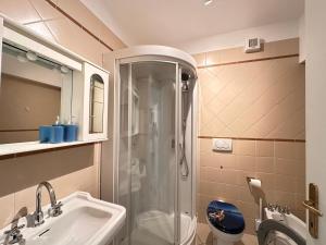 a bathroom with a shower and a sink and a toilet at Marina dei Sogni - Appartamento fronte mare con terrazza e aria condizionata in San Lorenzo al Mare +21 photos