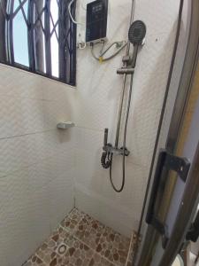 a bathroom with a shower with a glass door at Saceaas homes in Accra