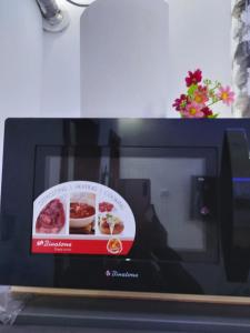 a microwave with a sign on the front of it at Saceaas homes in Accra +7 photos