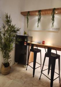 a table and two chairs in a room with plants at Sun Rimba Home by Ipoh Maju Stay in Ipoh