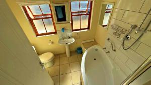 a small bathroom with a toilet and a sink at Three Decks in Cape Town +28 photos