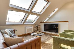a attic living room with skylights and a tv at Skyline View Condo Best downtown spot Park FREE in Indianapolis