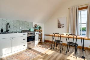 a kitchen with white cabinets and a table and chairs at Skyline View Condo Best downtown spot Park FREE in Indianapolis