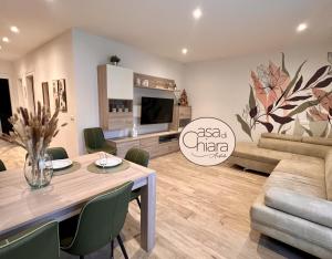 a living room with a table and a couch at Casa di Chiara Andalo Centro in Andalo +29 photos