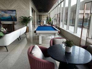 a room with a pool table and couches at Atithi Dream Studios in Gurgaon