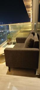 a couch in a room with a view of the city at Atithi Dream Studios in Gurgaon