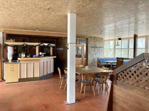 a kitchen and dining room with a table and chairs at Aotearoa - Mountain apartment in Bavaria, Mitterdorf - Mitterfirmiansreut in Mitterfirmiansreut
